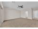 This carpeted bedroom features a ceiling fan and doors that lead to the bathroom at 6325 Carmel Creek Ave, Las Vegas, NV 89139