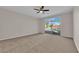 Spacious carpeted bedroom featuring a ceiling fan and sliding glass doors to the backyard pool at 6325 Carmel Creek Ave, Las Vegas, NV 89139