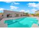 A backyard pool with built-in spa surrounded by a concrete patio and the house's exterior at 6325 Carmel Creek Ave, Las Vegas, NV 89139