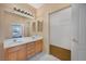 Bathroom featuring double sinks with modern lighting and a walk-in closet at 6701 Dorita Ave # 202, Las Vegas, NV 89108