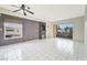 Well-lit living area boasting tile flooring, ceiling fan, and sliding glass door leading to the patio at 6701 Dorita Ave # 202, Las Vegas, NV 89108