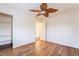 Bedroom with hardwood floors and a ceiling fan, plus an open closet and bathroom at 689 Lucky Pine St, Henderson, NV 89002