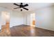 Bright bedroom featuring wood-look flooring, ceiling fan, and ensuite bathroom access at 689 Lucky Pine St, Henderson, NV 89002