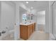 Bright bathroom featuring double sinks, and a large mirror at 7022 Feather Hill St, North Las Vegas, NV 89086