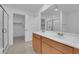 Bathroom features double sinks, a walk-in closet, and a glass-enclosed shower at 7022 Feather Hill St, North Las Vegas, NV 89086