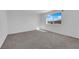 Bedroom with carpet flooring, light walls, and a view to the neighborhood at 7022 Feather Hill St, North Las Vegas, NV 89086