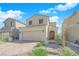 Charming two-story home featuring desert landscaping, a two-car garage, and a welcoming front entrance at 7022 Feather Hill St, North Las Vegas, NV 89086