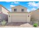 Home with a two-car garage with brick paver driveway and well-maintained landscaping at 7022 Feather Hill St, North Las Vegas, NV 89086