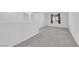 Upstairs hallway featuring neutral colors, carpet, and a view to the window at 7022 Feather Hill St, North Las Vegas, NV 89086