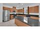 Bright kitchen showcases stainless steel appliances, granite countertops, and an island at 7022 Feather Hill St, North Las Vegas, NV 89086