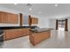 Well-appointed kitchen featuring black countertops, an island, and modern appliances for culinary enthusiasts at 7022 Feather Hill St, North Las Vegas, NV 89086