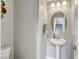 Elegant half-bathroom with stylish pedestal sink and modern decor at 7061 Tilligerry St, North Las Vegas, NV 89084