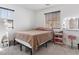 Cozy bedroom featuring plush carpet, a queen-sized bed and a vanity with Hollywood-style lighting at 715 Pickled Pepper Pl, Henderson, NV 89011