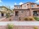 Charming two-story townhome showcasing stone accents, neutral stucco, and low-maintenance landscaping at 715 Pickled Pepper Pl, Henderson, NV 89011