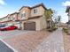 This home boasts a two-car garage, a neutral stucco facade and a stone-paver driveway at 715 Pickled Pepper Pl, Henderson, NV 89011