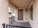 Close-up of front porch showing brick flooring, a security gate, and a classic outdoor lantern at 715 Pickled Pepper Pl, Henderson, NV 89011