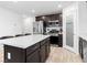 Contemporary kitchen featuring stainless steel appliances and dark wood cabinets, adjacent to a pantry at 715 Pickled Pepper Pl, Henderson, NV 89011