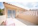 Enclosed balcony with sun-bathing lounge set against tan textured building with a terracotta tile roof at 7566 Spanish Bay Dr, Las Vegas, NV 89113