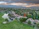 Stunning aerial view of a home with red tile roof on a golf course with a pond and mountain views at 7889 Harbour Towne Ave, Las Vegas, NV 89113