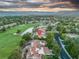 Community aerial view featuring a golf course, mature trees, and mountain views at 7889 Harbour Towne Ave, Las Vegas, NV 89113