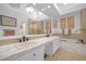 Bright bathroom featuring double vanity sinks, a soaking tub, and modern fixtures at 7889 Harbour Towne Ave, Las Vegas, NV 89113