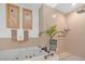 Luxurious bathroom featuring a soaking tub and walk-in shower with neutral tile and artful decor at 7889 Harbour Towne Ave, Las Vegas, NV 89113
