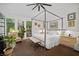 Comfortable bedroom with a four-poster bed, outdoor views, and modern décor at 7889 Harbour Towne Ave, Las Vegas, NV 89113