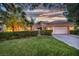 Charming single-story home featuring a well-manicured lawn, mature landscaping, and a two-car garage at 7889 Harbour Towne Ave, Las Vegas, NV 89113