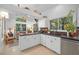 Bright kitchen featuring modern appliances, white cabinetry, and a view of the living space at 7889 Harbour Towne Ave, Las Vegas, NV 89113
