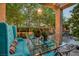 Serene outdoor patio with a glass table, blue seating, and lush landscaping at 7889 Harbour Towne Ave, Las Vegas, NV 89113