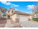 Two-story house with a two-car garage and desert landscaping, creating a low-maintenance front yard at 7961 Willow Pines Pl, Las Vegas, NV 89143