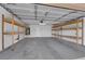 Spacious garage featuring ample storage space with shelving units and a clean epoxy floor at 7961 Willow Pines Pl, Las Vegas, NV 89143