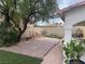 Backyard with pavers, artificial turf, desert landscaping, and a covered patio at 8396 Yamhill St, Las Vegas, NV 89123