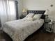 Bedroom boasting a comfortable bed with patterned bedspread and natural lighting at 8396 Yamhill St, Las Vegas, NV 89123
