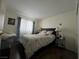 Bedroom featuring a dark wood floor, a patterned bedspread, and bright natural light at 8396 Yamhill St, Las Vegas, NV 89123