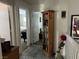 Hallway with tiled floor, wooden bookcase, and view into the bedroom at 8396 Yamhill St, Las Vegas, NV 89123