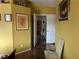 Bright hallway featuring warm wall color, hardwood floors, and a view into another room at 8396 Yamhill St, Las Vegas, NV 89123