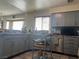 Open kitchen with a mobile island, grey cabinets, and tiled countertops at 8396 Yamhill St, Las Vegas, NV 89123