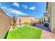 Spacious backyard featuring a seating area, turf, and tasteful landscaping elements at 8502 Torozo Ave, Las Vegas, NV 89149