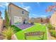 Expansive backyard with a patio, outdoor seating, turf, and manicured garden at 8502 Torozo Ave, Las Vegas, NV 89149