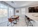 Bright dining area with modern table, chairs and natural light from large sliding glass doors at 8502 Torozo Ave, Las Vegas, NV 89149