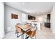 Bright dining area with a contemporary table, chairs, and adjacent kitchen with barstool seating at 8502 Torozo Ave, Las Vegas, NV 89149