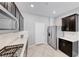 Modern kitchen with dark cabinetry, stainless steel appliances, and quartz countertops at 8502 Torozo Ave, Las Vegas, NV 89149