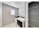 Laundry room with modern washer and dryer, plus shelving for storage, offers convenience and organization at 8502 Torozo Ave, Las Vegas, NV 89149