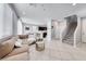 Cozy living room open to the kitchen, features tile floors, a plush sectional, and modern decor at 8502 Torozo Ave, Las Vegas, NV 89149