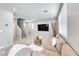Open-concept living room showcasing tile flooring, a sectional sofa, and a staircase to the second floor at 8502 Torozo Ave, Las Vegas, NV 89149