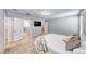 Comfortable main bedroom featuring neutral tones, a large bed, and access to various areas of the home at 8502 Torozo Ave, Las Vegas, NV 89149