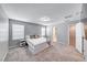 Inviting main bedroom with a large bed, plush carpet, and a view of the ensuite bathroom and walk-in closet at 8502 Torozo Ave, Las Vegas, NV 89149
