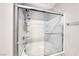 The bright bathroom features a glass-enclosed shower over the bathtub, with white subway tile and chrome fixtures at 8502 Torozo Ave, Las Vegas, NV 89149
