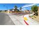 Neighborhood view showing a street corner, residences, sidewalks, and landscaping at 8502 Torozo Ave, Las Vegas, NV 89149